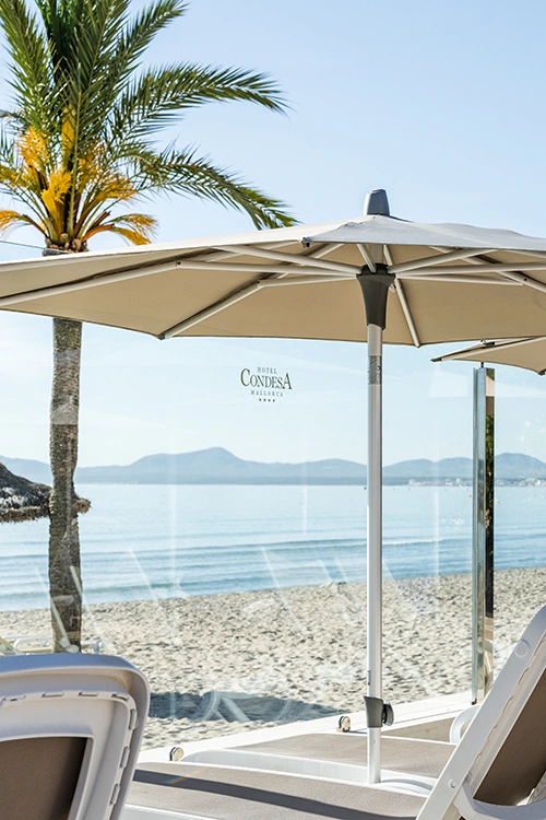 beach in front of Hotel Condesa Sun lounger area in front of the beach at Hotel Condesa